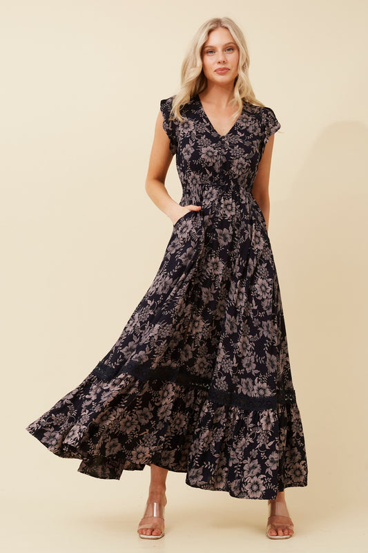 Morocco Floral Maxi Dress in Black Floral – lightweight woven polyester texture, unlined for cooling, regular fit with shirred waist. Front view.