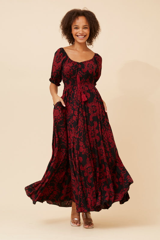Daisy Floral Maxi Dress in Black – soft lightweight woven texture, unlined for breathable comfort, regular fit with shirred waist and tassel tie. Front view.